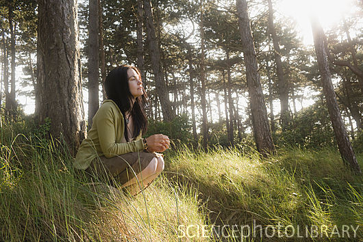 Woman crouching in contemplation